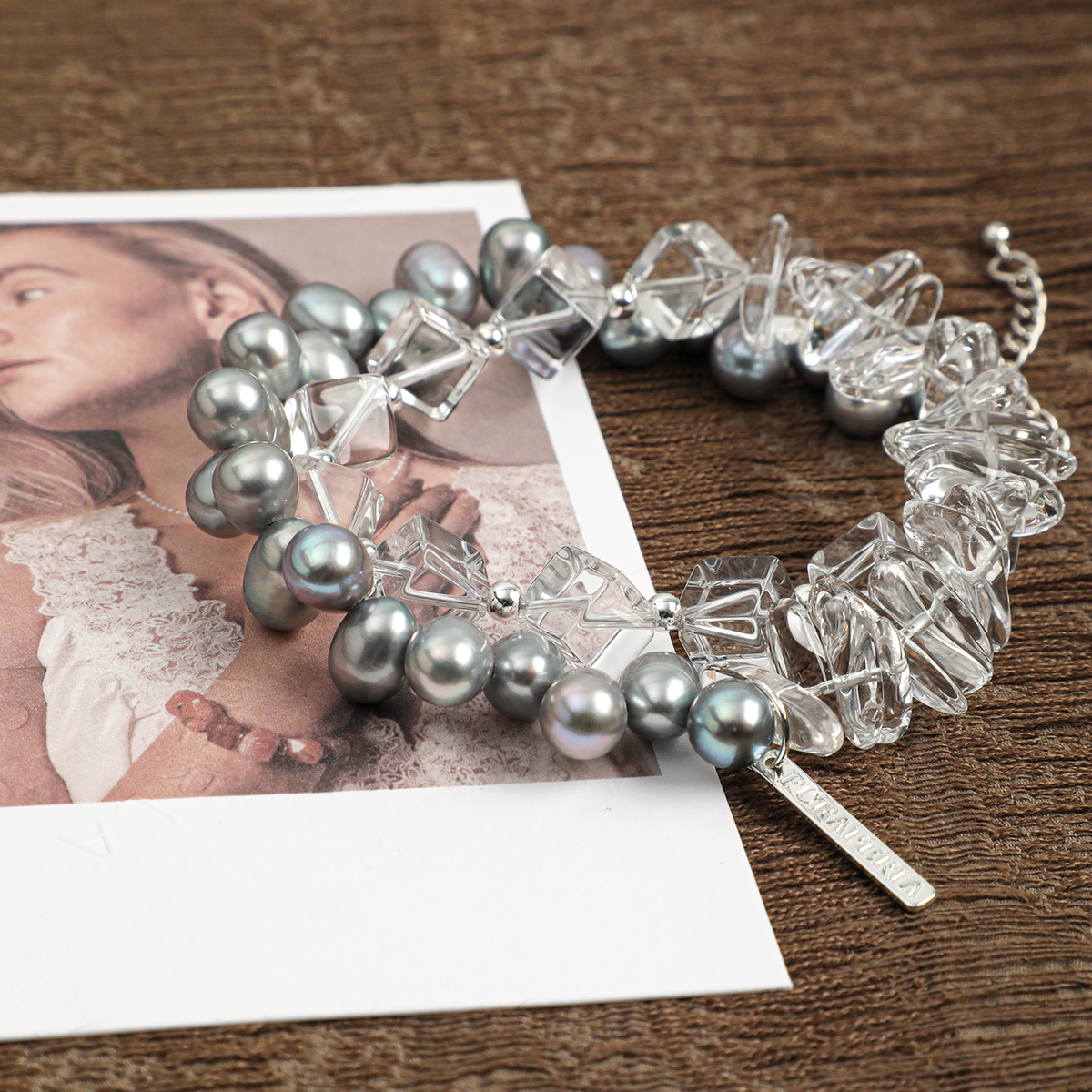Angled view of gray pearl and clear quartz bracelet