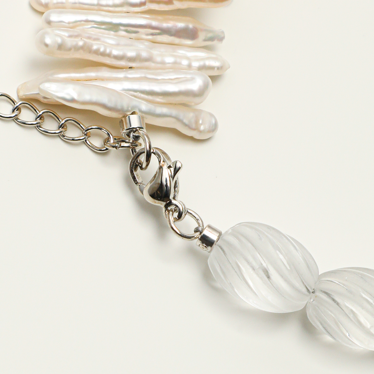 Lobster clasp and extender chain on quartz and pearl bracelet
