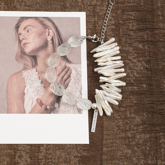 Clear quartz and stick pearl bracelet on brown fabric