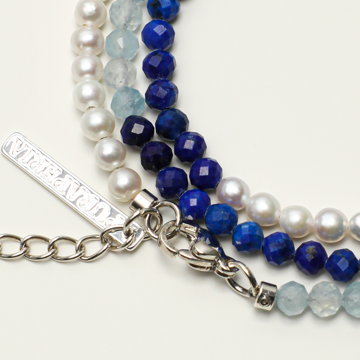 Long engraving tag, lobster clasp and three-strand connection detail