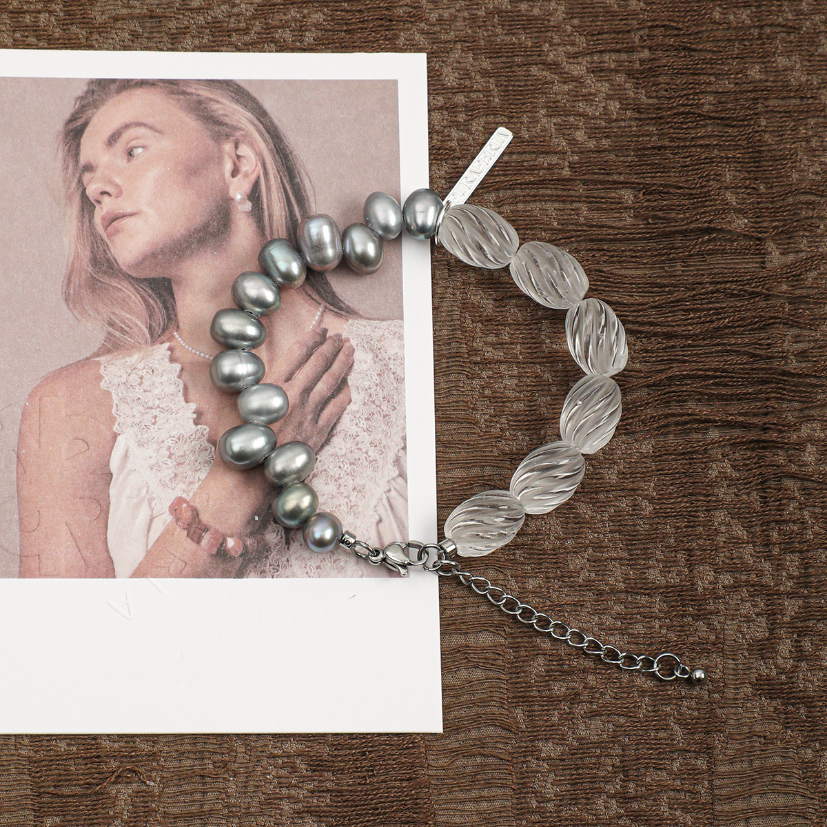 Clear quartz and gray freshwater pearl bracelet in a lifestyle setting
