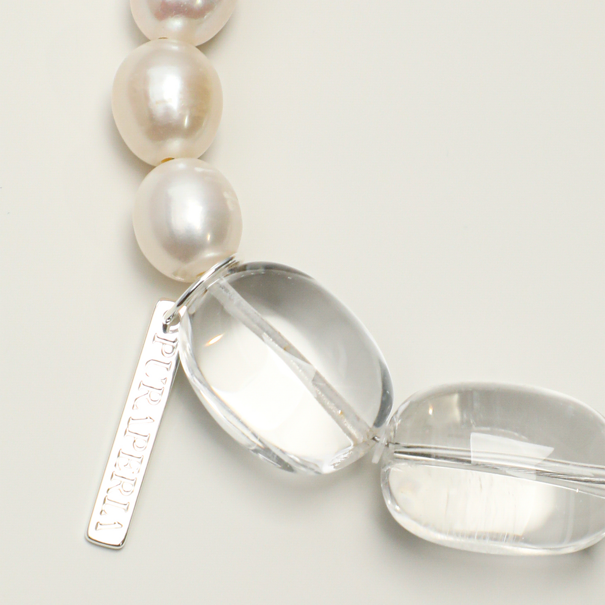 Freshwater pearls, clear quartz and long tag detail
