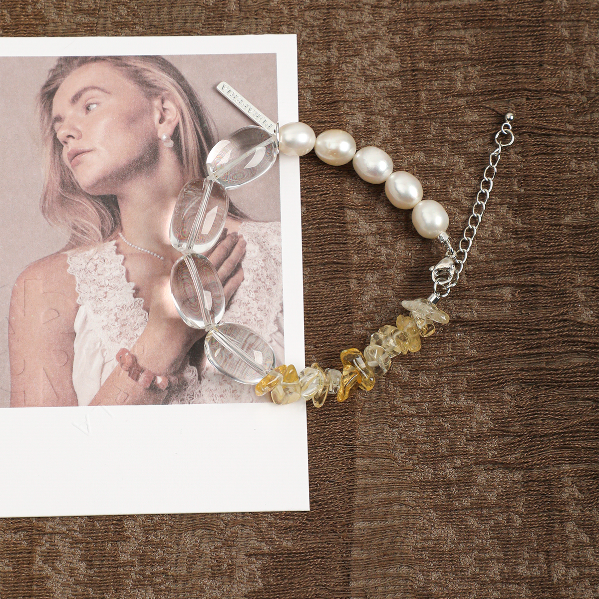 Clear quartz, citrine and pearl bracelet styled on brown fabric
