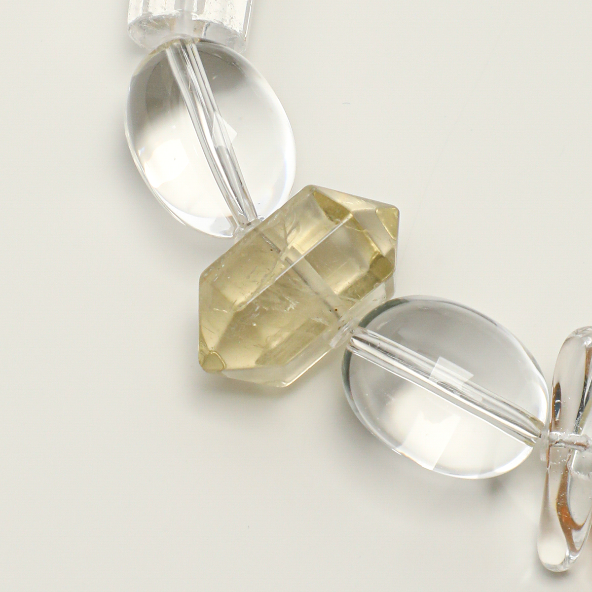 Citrine double-point bead between clear quartz oval beads