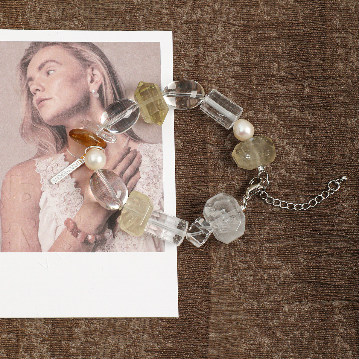 Clear quartz and citrine bracelet styled on brown fabric