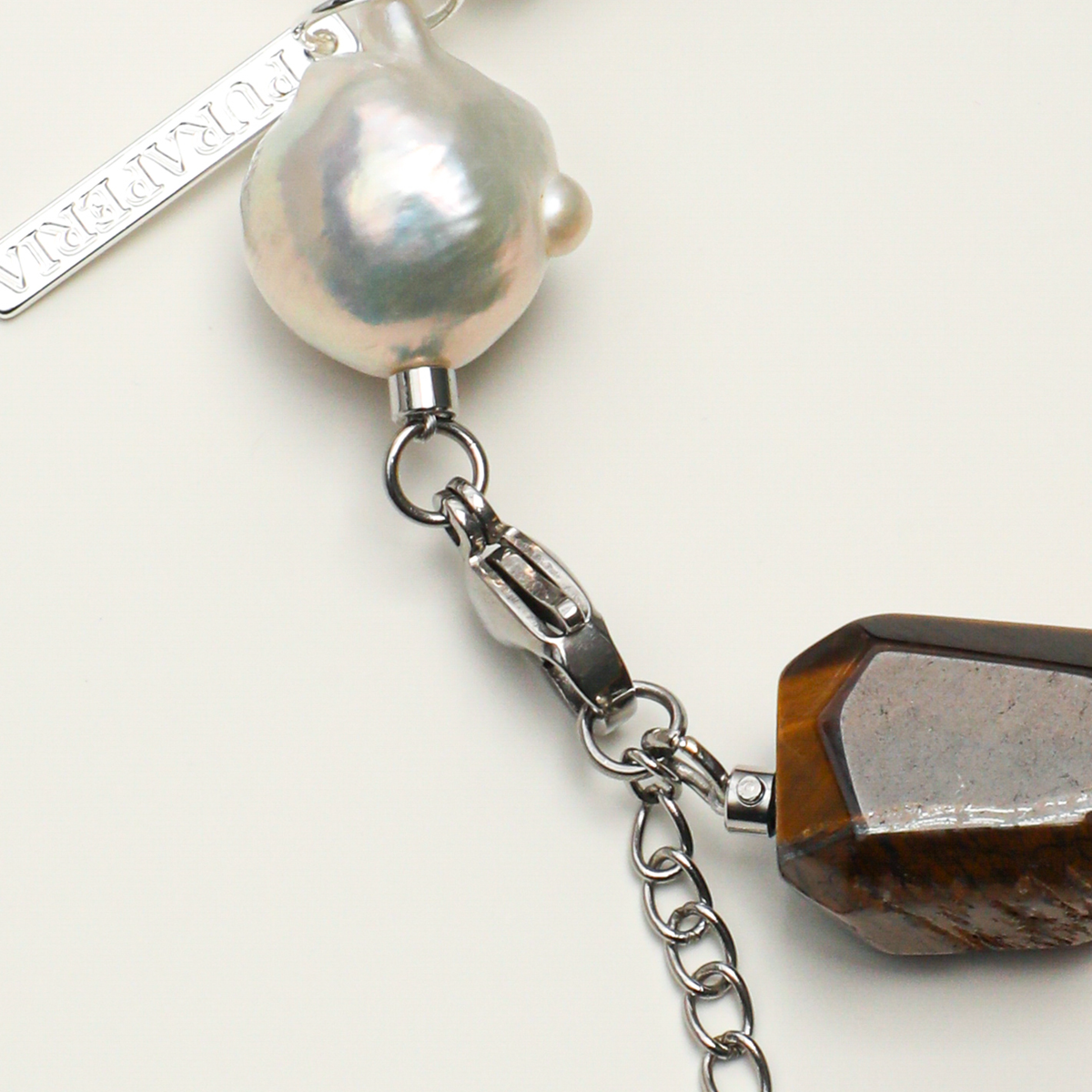 Silver-plated 316L stainless steel lobster clasp, extender chain, and freshwater pearl detail