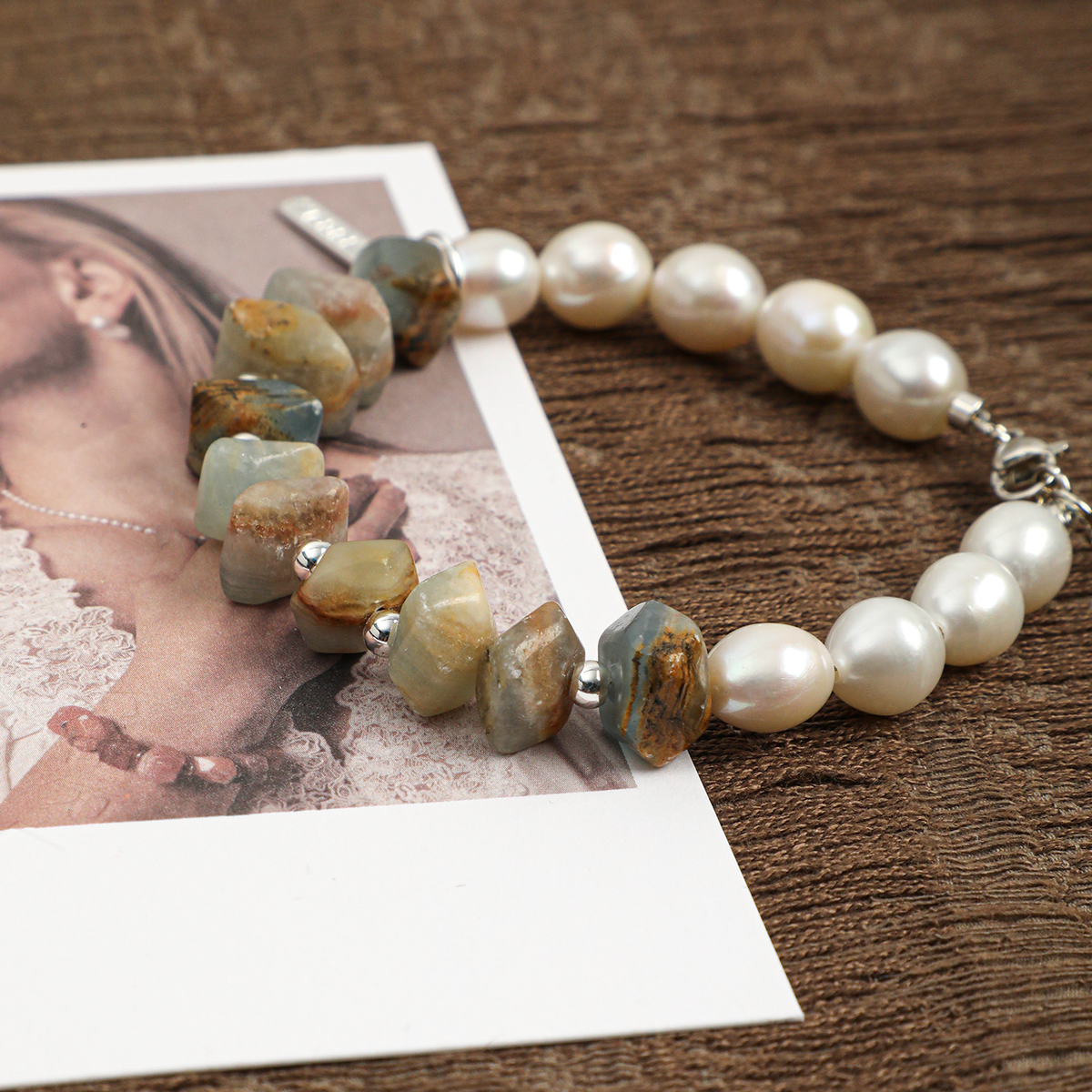 Close view of Blue Luster stone, pearls, and silver-toned accents