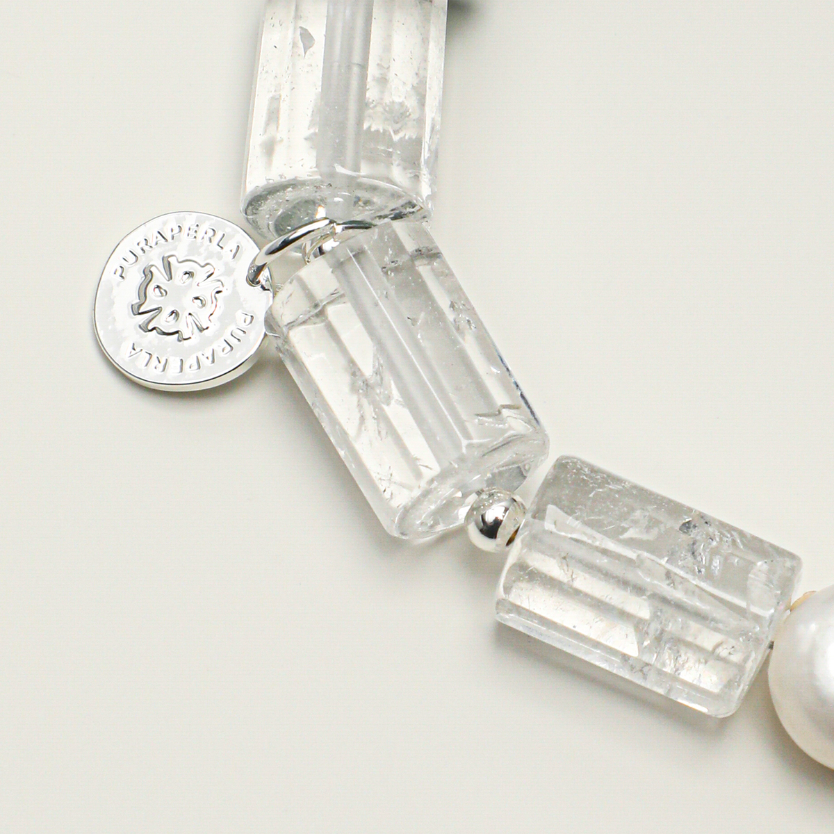 Clear quartz barrel beads and silver-plated 316L stainless steel round tag detail