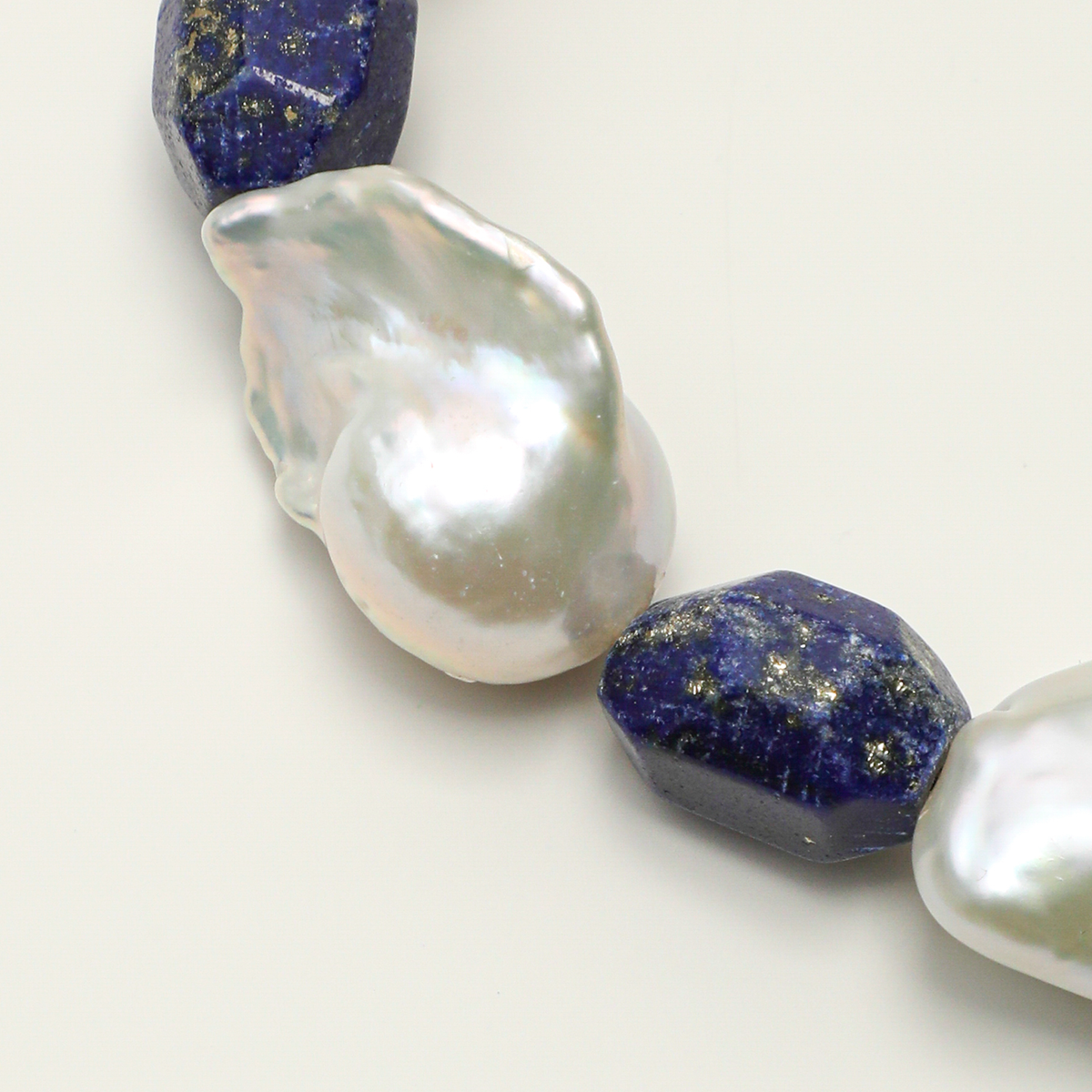 Natural baroque pearl and freeform lapis lazuli detail