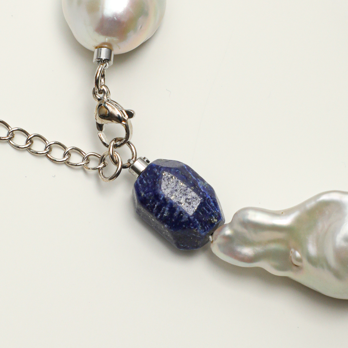 Lobster clasp, extender chain, lapis lazuli and baroque pearl detail