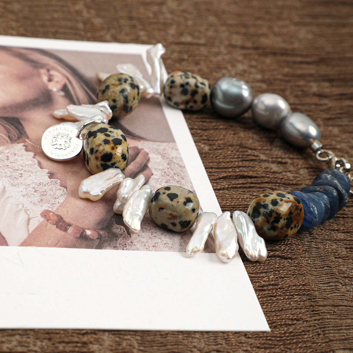 Dalmatian jasper, kyanite and baroque pearl bracelet styled close-up