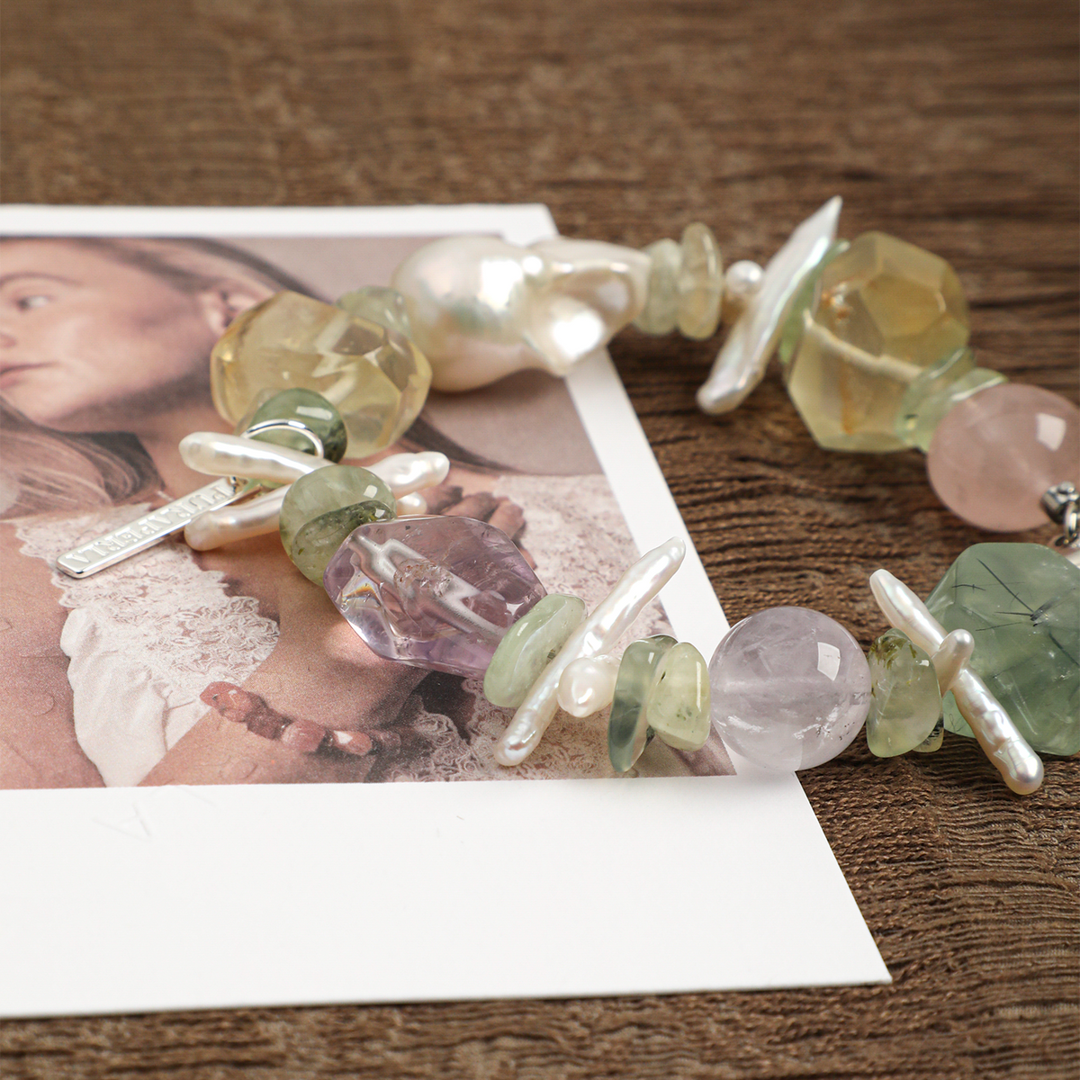 Pastel mixed gemstone and baroque pearl bracelet styled close-up